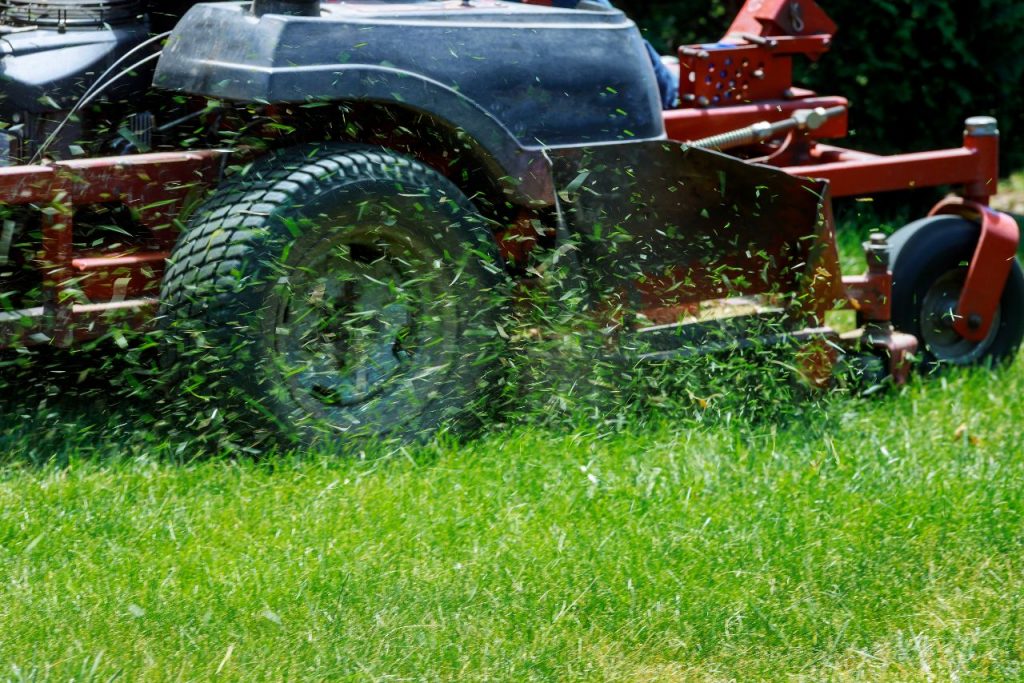 Kissimmee Lawn Service Red Mower Cutting Lawn